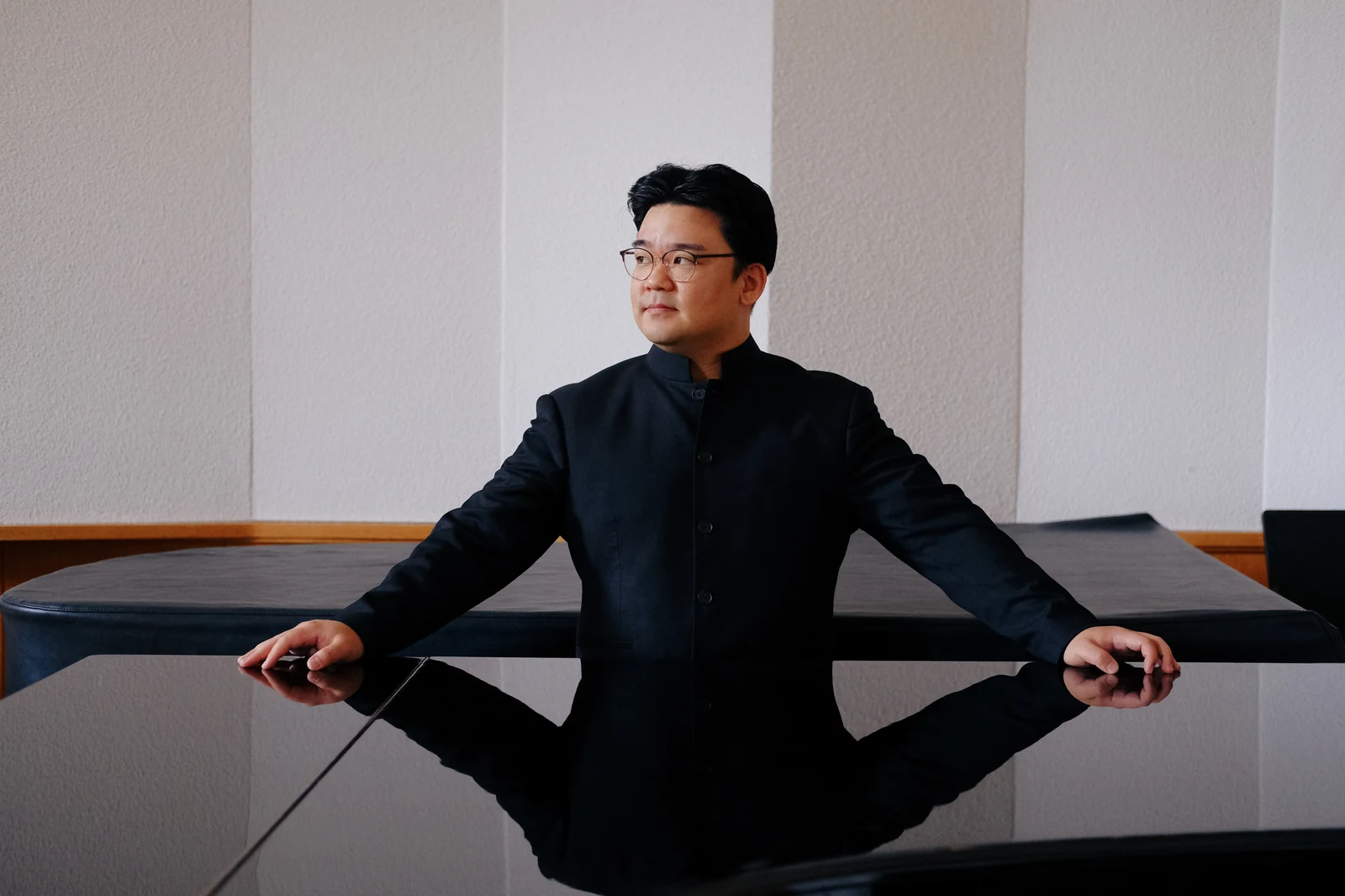 Sungwook Kim beside a piano and score
